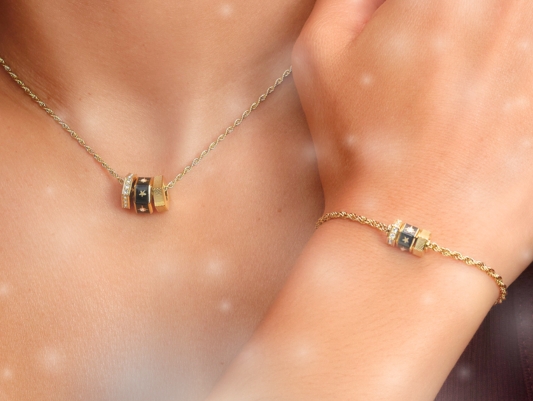 A diamond bangle being placed on a ladies wrist