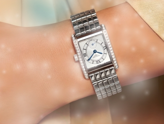 A close up of a TAG Heuer Watch on a ladies watch whilst hanging a bauble on a tree