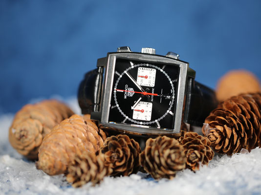 TAG Heuer Green Carrera watch with black leather strap on a green velvet background 