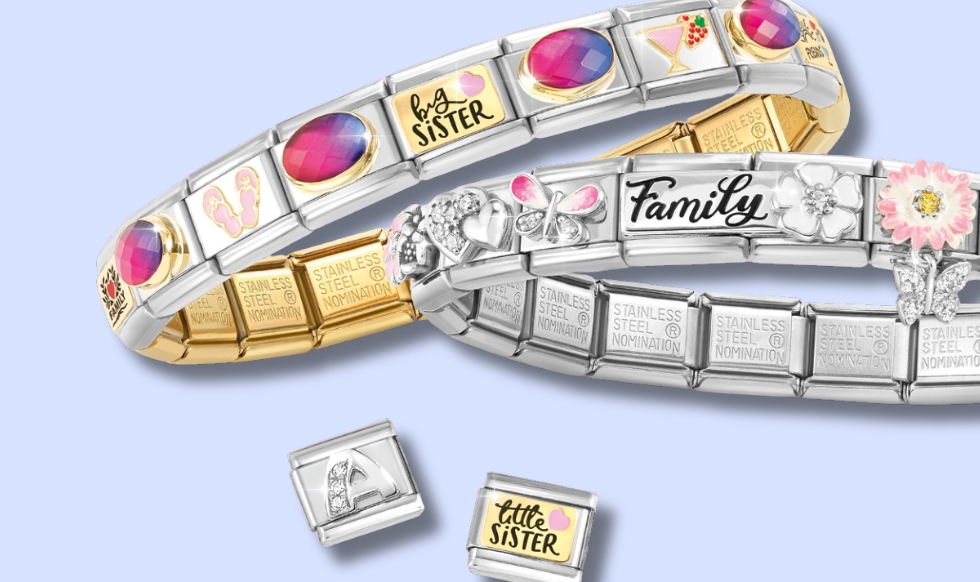 silver and gold Nomination composable bracelets on a blue backdrop with 2 extra charm links