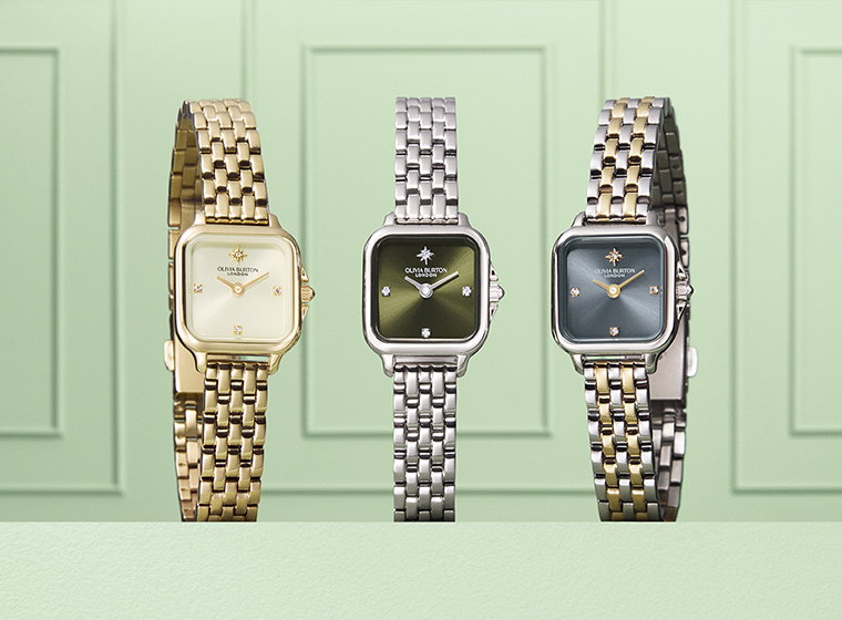 3 rectangle watches sat on a green block with green background