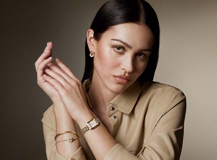 BOSS gold tone watch with a green dial on a blonde lady