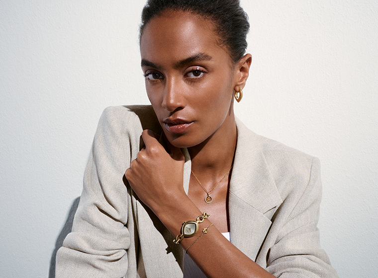 BOSS gold tone watch with a green dial on a blonde lady