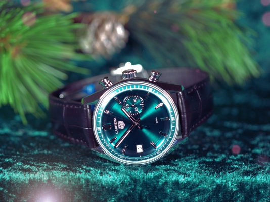 TAG Heuer Green Carrera watch with black leather strap on a green velvet background 