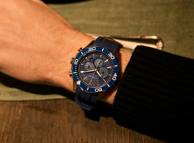 yellow and black citizen watch on a mans arm 