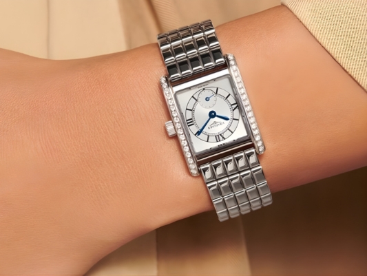 A close up of a TAG Heuer Watch on a ladies watch whilst hanging a bauble on a tree