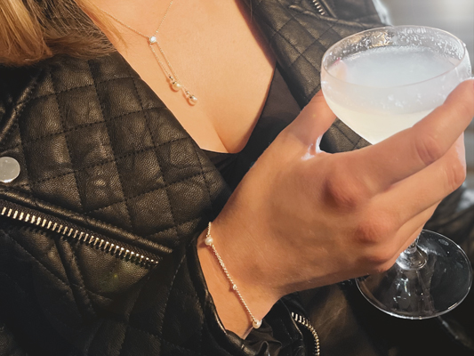 A diamond bangle being placed on a ladies wrist