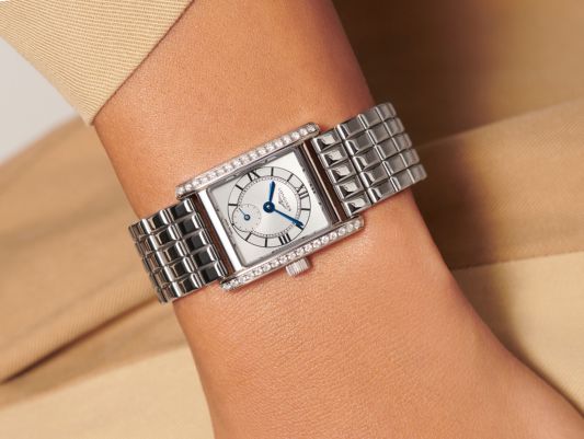 A close up of a TAG Heuer Watch on a ladies watch whilst hanging a bauble on a tree