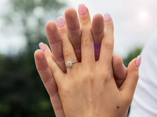 Couples hands with engagement ring