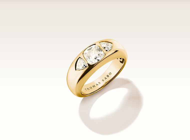 thomas sabo butterfly designed gold ring sat on a white flower