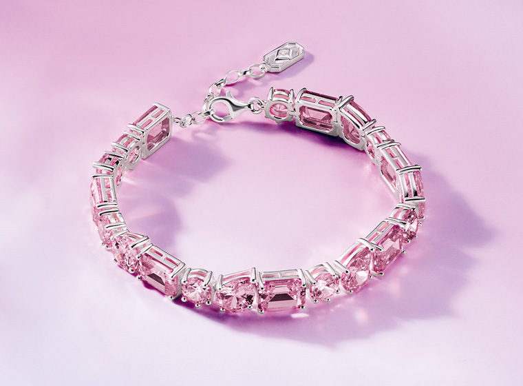 Pink stone silver tennis bracelet on a pink bracelet