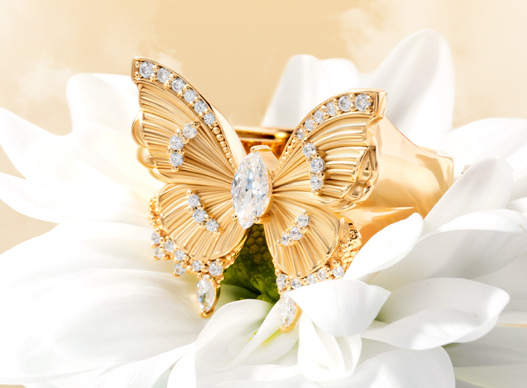 thomas sabo butterfly designed gold ring sat on a white flower